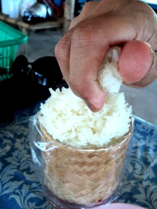 Thais eat steamed sticky rice with the hand